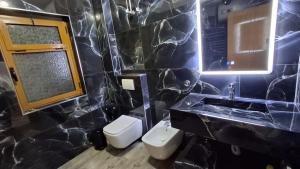 a bathroom with a toilet and a sink and a mirror at The Sweet Home in Pogradec +43 photos