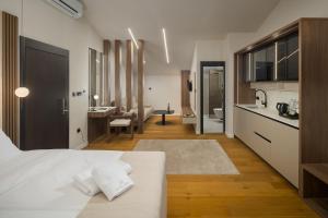 a bedroom with a white bed and a bathroom at Heritage Hotel Ames in Poreč