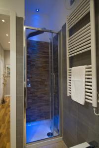 a shower with a glass door in a bathroom at Ema's Home in Portofino