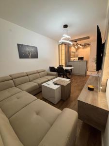 a living room with a couch and a table at Apartman NOVA in Kragujevac