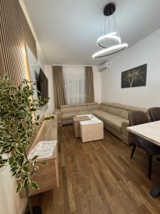 a living room with a couch and a table at Apartman NOVA in Kragujevac