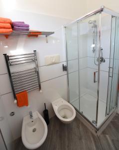 a bathroom with a toilet and a glass shower at Appartamento Corso Italia 250 in Sorrento