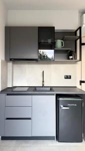 a kitchen with a sink and a stove at Ammos Maisonettes in Pefkari +29 photos