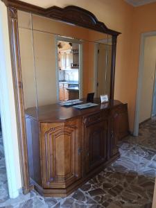 a large wooden cabinet with a mirror in a room at A Lucita-Ribeira Sacra in Rubiacós +5 photos