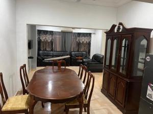 a living room with a wooden table and a couch at The Senegambia Hideaway in Amdalai