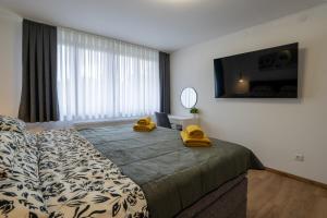 a bedroom with a bed with yellow shoes on it at The Nest Otočac in Otočac