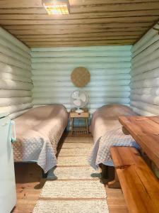 a room with two beds in a log cabin at Löydön Kartano Camping in Mikkeli +31 photos