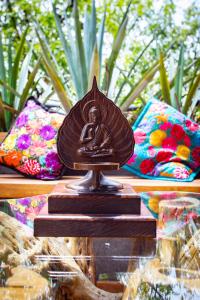 a statue of a woman on a table with pillows at Hotel Parque España in Mexico City +31 photos