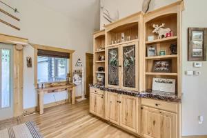 a kitchen with wooden cabinets and a desk at Mountain Retreat - Deck Views - Sleeps 10 in Black Hawk