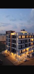 a large building with lights in a parking lot at Toot Suites Studio in Abha