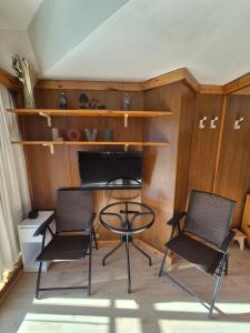 a room with two chairs and a glass table at ''BalconyView'' by Staymarilleva1400 in Marilleva