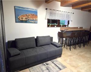 a living room with a couch and a table at Petar in Kamešnica