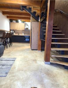a living room with a staircase and a kitchen at Petar in Kamešnica +5 photos