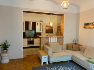 a living room with a couch and a kitchen at Old town Wall Radovljica - Appartment in Radovljica