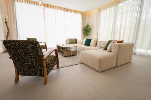 a living room with a couch and a chair at Villa de luxe, petit déjeuner compris Golf in Marrakesh +35 photos