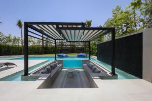 a swimming pool with a table and chairs in a house at Villa de luxe, petit déjeuner compris Golf in Marrakesh