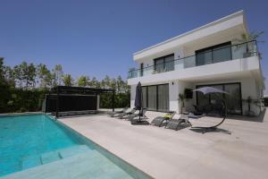 a house with a swimming pool next to a building at Villa de luxe, petit déjeuner compris Golf in Marrakesh