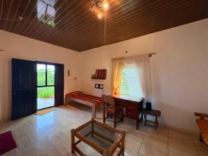 a living room with a piano and a table at Sunflower Beach Resort in Senya Beraku