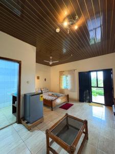 a living room with a couch and a tv at Sunflower Beach Resort in Senya Beraku