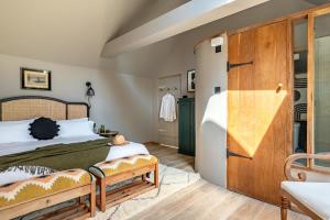 a bedroom with a bed and a wooden door at 3 Bed in Ditchingham oc-s42751 in Ditchingham