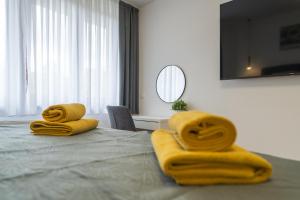 two towels with faces on top of a bed at The Nest Otočac in Otočac