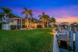 a house on the water with a marina at Villa Hibiscus-Waterfront-Free Heated Pool-Dock-Bikes-Other Amenities in Punta Gorda