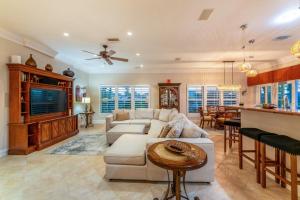 a living room with a couch and a table at Villa Hibiscus-Waterfront-Free Heated Pool-Dock-Bikes-Other Amenities in Punta Gorda