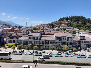 a city with cars parked in a parking lot at Golden Age Rooftop Apartment in Ohrid