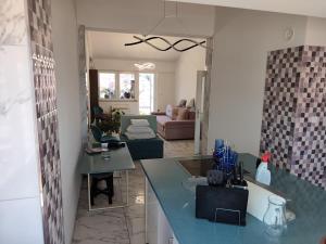 a kitchen and living room with a blue counter top at Golden Age Rooftop Apartment in Ohrid
