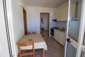 a small kitchen with a table and chairs in a room at Fondaco del Capo in Capo Vaticano +65 photos