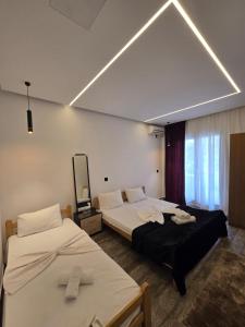 a room with two beds and a mirror at Casa Lu in Ulcinj
