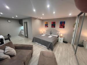 a bedroom with a bed and a couch at Apartmány Centrum Trenčín - Greenyard in Trenčín