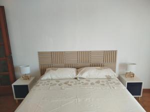 a bedroom with a large bed with two night stands at Camera matrimoniale Capannori, Lucca in Capannori