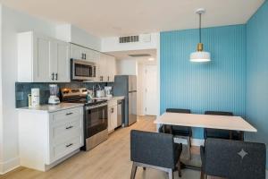 a kitchen with a table and chairs in a room at Coastal Modern Oceanfront 2BR Yachtsman S506 in Myrtle Beach +66 photos