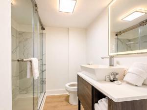 a bathroom with a sink and a glass shower at Coastal Modern Oceanfront 2BR Yachtsman S506 in Myrtle Beach