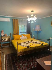 a bedroom with a bed with yellow pillows at Vila 4 Stinet in Pogradec