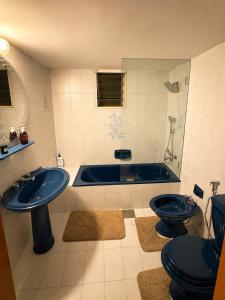 a bathroom with a sink and a tub and two toilets at Zaaytre house in Ḩayy al Mukhabbaʼ