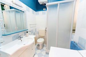 a bathroom with a toilet and a sink and a shower at Casa Antonella in Trabia