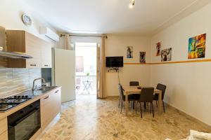 a kitchen and dining room with a table and chairs at Casa Antonella in Trabia +12 photos