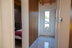 a hallway leading to a bedroom with a window at Villa Merak House in Bijelo Brdo