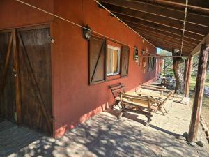 a group of benches sitting on the side of a building at Calma chicha casa 1 in Cortaderas