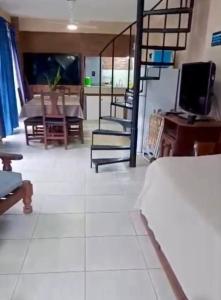a living room with a television and a table and chairs at Casa de vacaciones Naty in Villa Carlos Paz +3 photos
