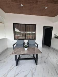 a living room with a table and two chairs at Paradise 1 in Jacó