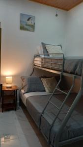 two bunk beds in a room with a lamp at Paradise 1 in Jacó