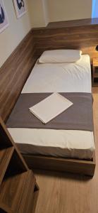 a bed in a room with a wooden floor at Drei Schweizer Hotel in Neuwied