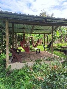a picnic shelter with hammocks and a picnic table at Altos de Shalem casa canaan in Anolaima