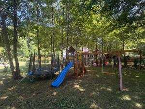 a playground with a slide in a park at Holiday Home UnaPark in Krakovo