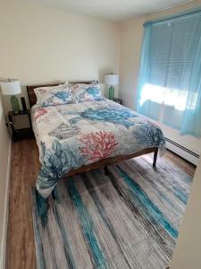 a bedroom with a bed and a window at Heavenly Properties SLM in Scituate