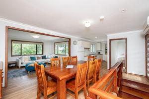 a dining room and living room with a table and chairs at Relax Moore - Close to Beach in Guilderton
