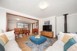 a living room with a couch and a tv at Relax Moore - Close to Beach in Guilderton